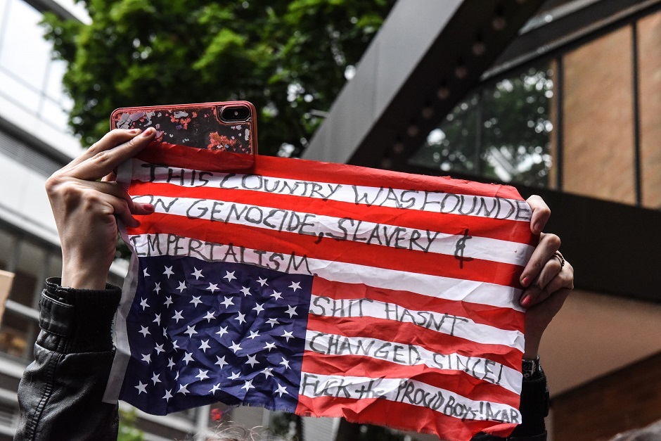 a masked counter protester attends an alt right rally in portland photo afp