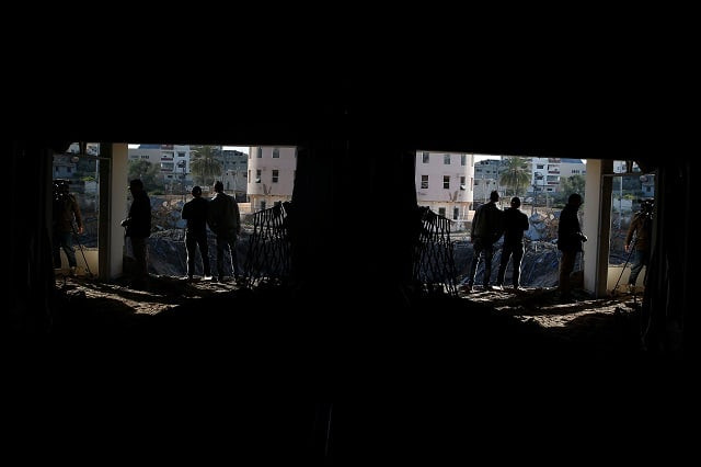 palestinians are seen reflected in a mirror near the office of hamas chief ismail haniyeh after it was destroyed by an israeli air strike in gaza city in march 2019 photo reuters palestinians are seen reflected in a mirror near the office of hamas chief ismail haniyeh after it was destroyed by an israeli air strike in gaza city in march 2019 photo reuters