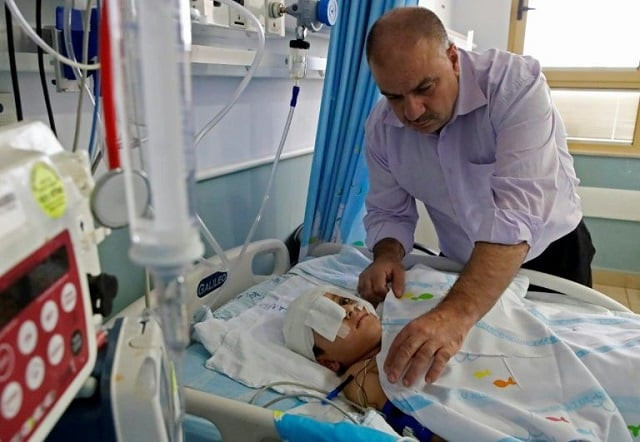 yassir shtewi sleeps each night by his son 039 s bed in an israeli hospital photo afp yassir shtewi sleeps each night by his son 039 s bed in an israeli hospital photo afp