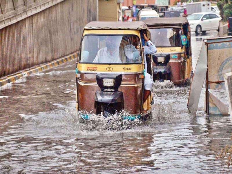 commuters face difficulty plying on the road in front of the national institute of child health due to the overflowing sewerage water the same road houses some of the largest public hospitals of the province several areas of the city have been affected by overflowing sewerage water after the recent rains photo app