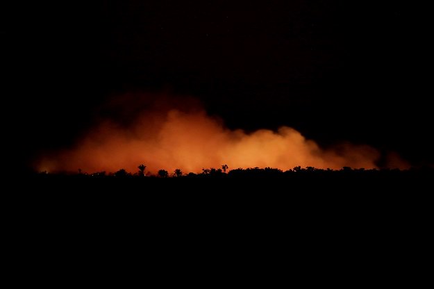 smoke billows during a fire in an area of the amazon rainforest photo reuters