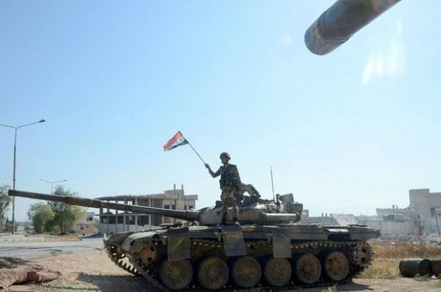 a syrian soldier waves a national flag atop a tank in the strategic town of khan sheikhun on saturday photo afp a syrian soldier waves a national flag atop a tank in the strategic town of khan sheikhun on saturday photo afp