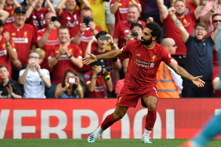 liverpool and city look set to do battle for the title again but the reds opened up an early five point lead over the champions who face bournemouth on sunday with a dominant display over the gunners photo afp