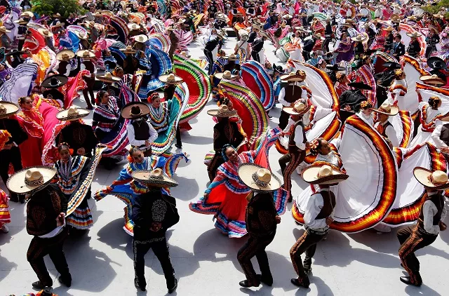couples dance to mariachi traditional music to break the guinness world record of largest mexican folk dance dancers in guadalajara mexico photo afp couples dance to mariachi traditional music to break the guinness world record of largest mexican folk dance dancers in guadalajara mexico photo afp