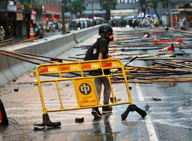 an anti extradition bill protester carries a barricade for blocking the road during a protest in hong kong china photo reuters an anti extradition bill protester carries a barricade for blocking the road during a protest in hong kong china photo reuters