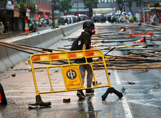 an anti extradition bill protester carries a barricade for blocking the road during a protest in hong kong china photo reuters