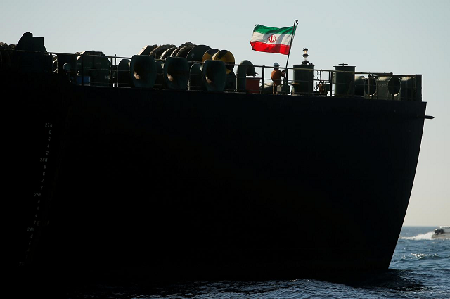 a crew member raises the iranian flag on iranian oil tanker adrian darya 1 previously named grace 1 as it sits anchored after the supreme court of the british territory lifted its detention order in the strait of gibraltar spain photo reuters