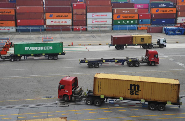 trucks transport containers at a port in qingdao shandong province photo reuters