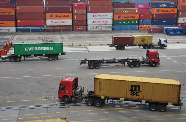 trucks transport containers at a port in qingdao shandong province photo reuters trucks transport containers at a port in qingdao shandong province photo reuters