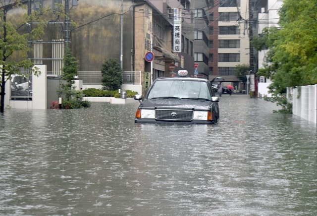 a taxi is stuck in floodwaters caused by heavy rain in saga southern japan photo reuters