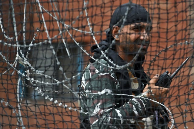 a security personnel stands guard on a street in srinagar photo afp a security personnel stands guard on a street in srinagar photo afp