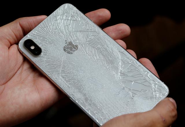 a worker refurbishes an apple iphone cell phone at a workshop of the oxflo company in france photo reuters file