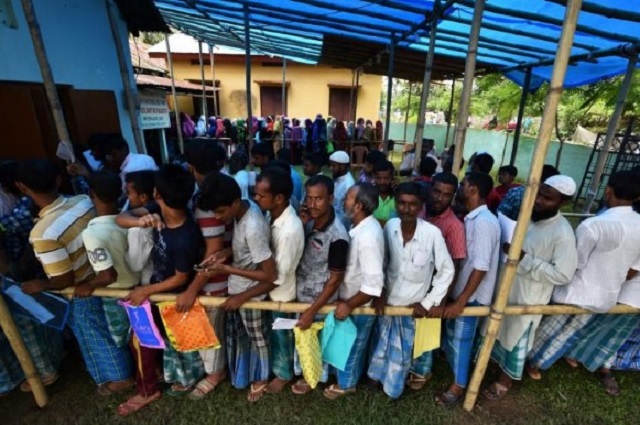 people wait in queue to check their names on the draft list at the national register of citizens nrc centre at a village in nagaon district assam state india photo reuters