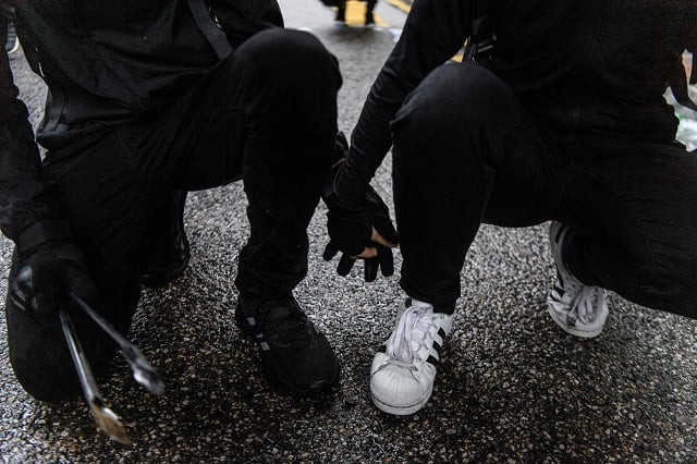 in this picture abby 19 and her boyfriend nick 20 hold hands as they crouch down on a road after they found each other in a shopping mall following their separation as tear gas was being fired by police during a protest in tsuen wan an area in the new territories in hong kong abby and nick 039 s relationship has blossomed on the barricades during hong kong 039 s long summer of protest photo afp in this picture abby 19 and her boyfriend nick 20 hold hands as they crouch down on a road after they found each other in a shopping mall following their separation as tear gas was being fired by police during a protest in tsuen wan an area in the new territories in hong kong abby and nick 039 s relationship has blossomed on the barricades during hong kong 039 s long summer of protest photo afp
