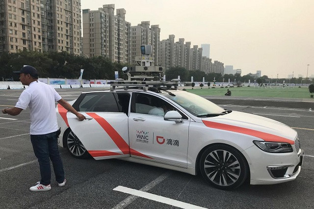 a man holds a door to a didi self driving car during the world artificial intelligence conference waic in shanghai china august 30 2019 photo reuters a man holds a door to a didi self driving car during the world artificial intelligence conference waic in shanghai china august 30 2019 photo reuters