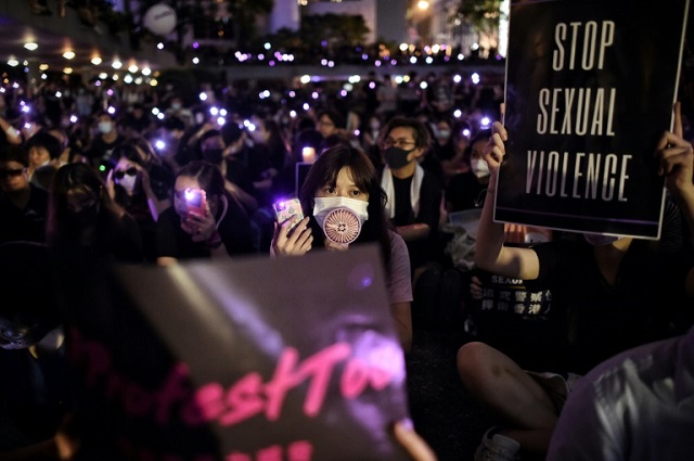 thousands rallied against alleged police sexual violence holding aloft purple lights in solidarity with abuse victims photo afp