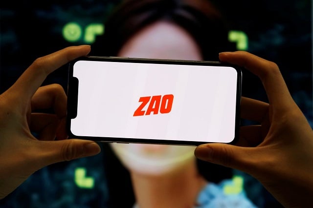 the logo of the chinese app zao which allows users to swap their faces with celebrities and anyone else is seen on a mobile phone screen in front of an advertisement of the app in this illustration picture taken september 2 2019 photo reuters