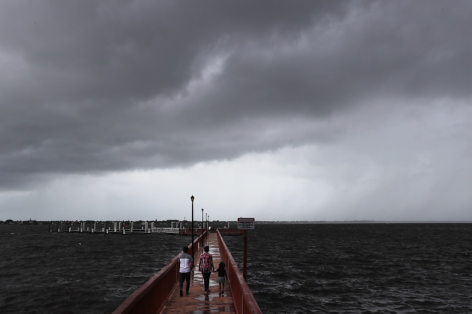 people walk along the boardwalk run as hurricane dorian continues to make its way toward the florida coast photo afp