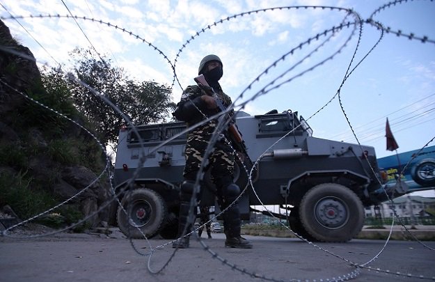 an indian security personnel stands guard on a deserted road during restrictions after scrapping of the special constitutional status for kashmir by the indian government in srinagar photo reuters