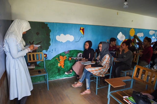 a teacher teachers her class in an institute in kabul photo afp