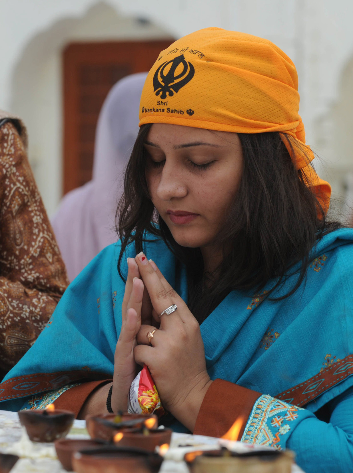 in this file photo a sikh devotee from india prays during the 542nd birth anniversary of guru nanak dev at nankana sahib photo afp