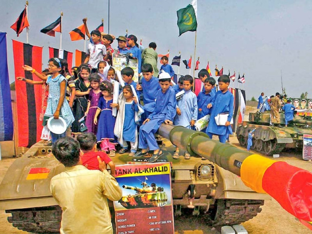 schoolchildren sit atop an al khalid tank on the occasion of pakistan defence day at col sher khan stadium in peshawar photo ppi schoolchildren sit atop an al khalid tank on the occasion of pakistan defence day at col sher khan stadium in peshawar photo ppi