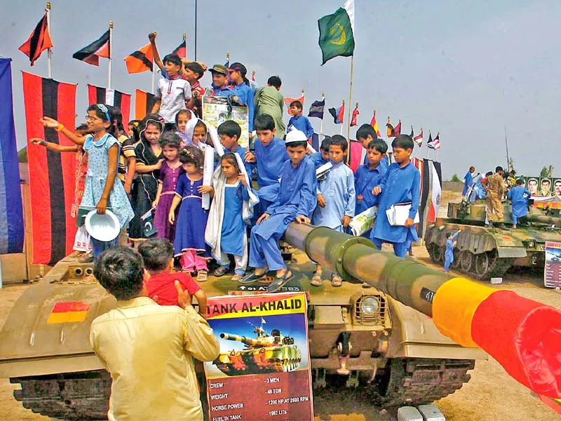 schoolchildren sit atop an al khalid tank on the occasion of pakistan defence day at col sher khan stadium in peshawar photo ppi schoolchildren sit atop an al khalid tank on the occasion of pakistan defence day at col sher khan stadium in peshawar photo ppi