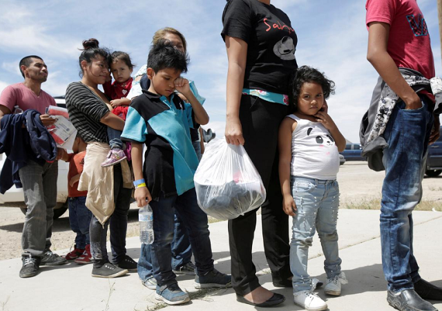 central american migrants stand in line before entering a temporary shelter after illegally crossing the border between mexico and the us in deming new mexico photo reuters