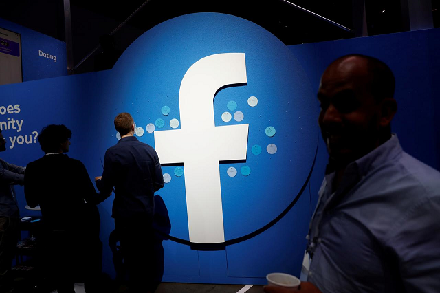 attendees walk past a facebook logo during facebook 039 s f8 developers conference in san jose california us april 30 2019 photo reuters