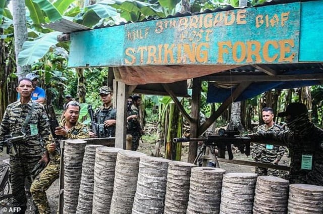 rebel fighters in the philippines are handing in their weapons in a process aimed at turning the moro islamic liberation front into a regular political party photo afp