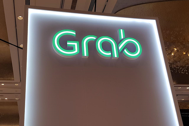 a grab logo is pictured at the money 20 20 asia fintech trade show in singapore march 21 2019 photo reuters