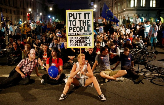 a demonstrator holds a banner during an anti brexit protest outside the houses of parliament in london photo reuters a demonstrator holds a banner during an anti brexit protest outside the houses of parliament in london photo reuters