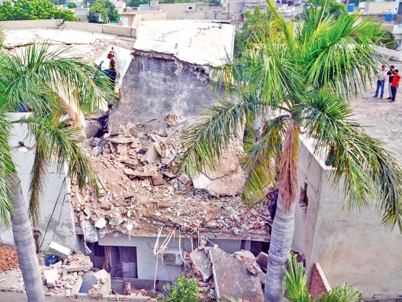 the huge impact damaged one portion of the two storey building photos online