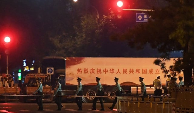 chinese paramilitary police march past trucks with propaganda slogans on beijing 039 s main east west boulevard during an overnight rehearsal for a military parade to mark communist china 039 s 70th anniversary photo afp chinese paramilitary police march past trucks with propaganda slogans on beijing 039 s main east west boulevard during an overnight rehearsal for a military parade to mark communist china 039 s 70th anniversary photo afp