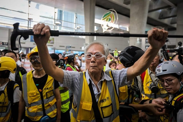 this picture taken on september 7 2019 shows quot grandpa wong quot 85 shielding protesters from the police by holding his walking stick up along with other quot silver hair quot volunteers in the tung chung district in hong kong despite his age wong is a regular sight at hong kong 039 s street battles hobbling towards police lines placing himself in between riot officers and hardcore protesters hoping to de escalate what have now become near daily clashes photo afp this picture taken on september 7 2019 shows quot grandpa wong quot 85 shielding protesters from the police by holding his walking stick up along with other quot silver hair quot volunteers in the tung chung district in hong kong despite his age wong is a regular sight at hong kong 039 s street battles hobbling towards police lines placing himself in between riot officers and hardcore protesters hoping to de escalate what have now become near daily clashes photo afp