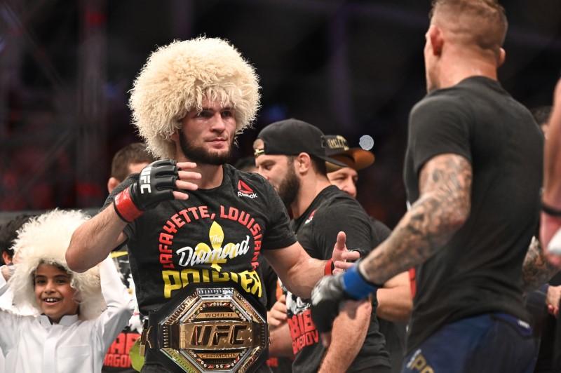 the dagestan native escaped a guillotine choke to take poirier s back before shifting his position and sinking into a rear naked choke photo reuters