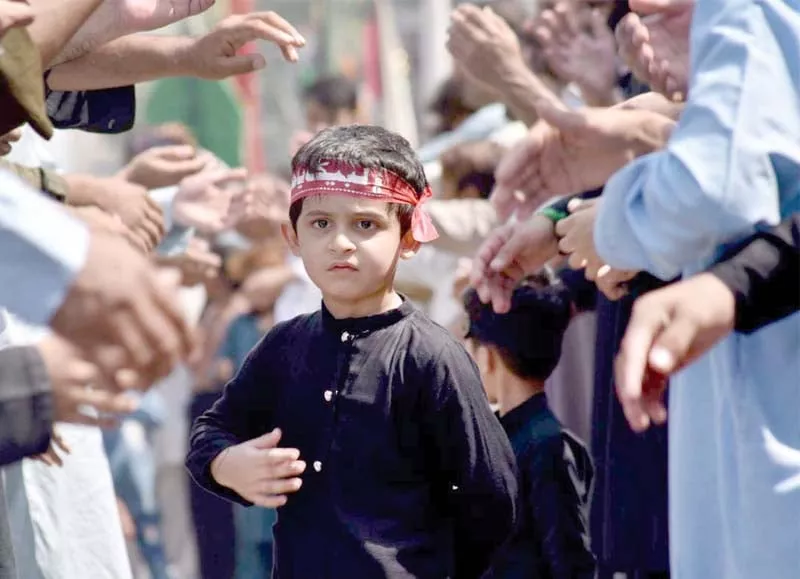a boy stands among mourners in a muharram procession in saddar bazaar of peshawar photos app ppi a boy stands among mourners in a muharram procession in saddar bazaar of peshawar photos app ppi