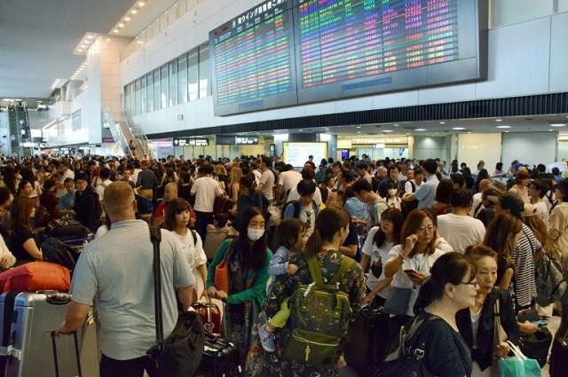 passengers wait at the arrivals hall of narita international airport for transportation as trains running to and from the airport were halted due to passing typhoon faxai in narita chiba prefecture on sepr 9 2019 photo afp