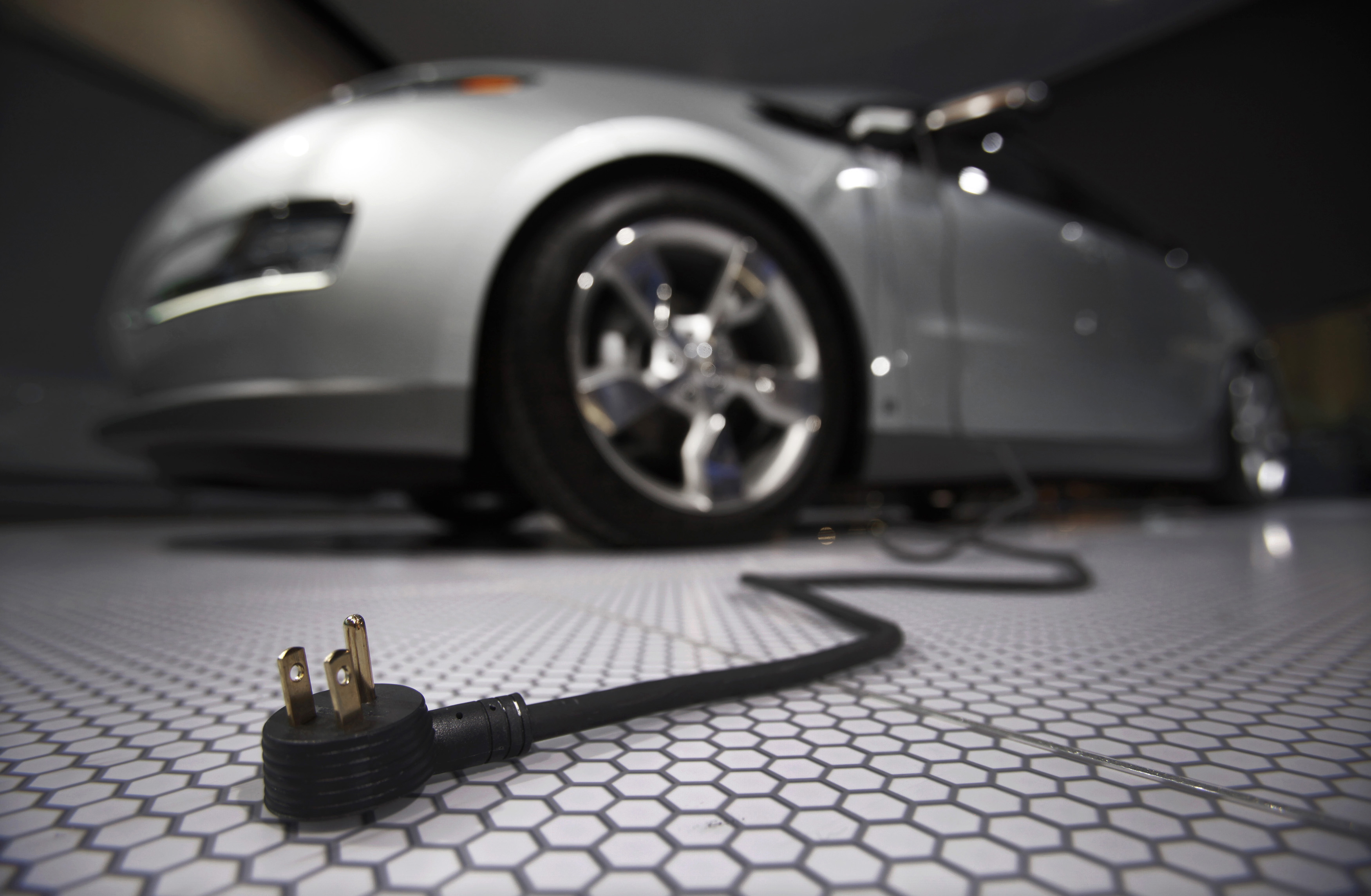 a plug is seen coming from an electric car during the north american international auto show in detroit michigan photo reuters