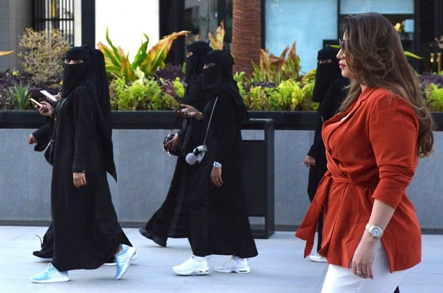 saudi human resources professional mashael al jaloud walks in western clothes past women wearing niqab an islamic dress code for women at a commercial area in the saudi capital riyadh photo afp saudi human resources professional mashael al jaloud walks in western clothes past women wearing niqab an islamic dress code for women at a commercial area in the saudi capital riyadh photo afp