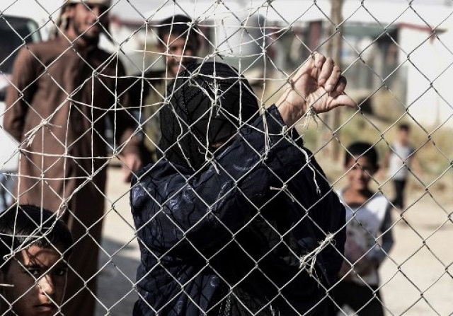 iraqis prepare to board a bus home to kirkuk at a camp for displaced people in hammam al alil south of the northern iraqi city of mosul on august 27 2019 the united nations fears the returnees could face danger back home photo afp