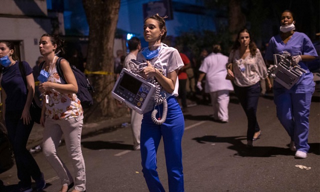 medical workers carry medical equipment to ambulances transferring patients during a fire at the badim private hospital in tijuca rio de janeiro on thursday night photo afp