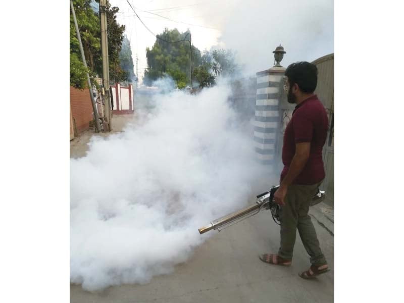 a technician busy in anti dengue fumigation in a rawalpindi neighbourhood on saturday photo express