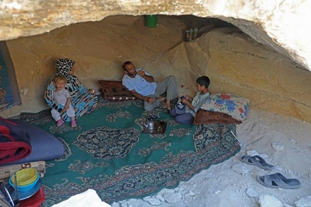 abu ahmad a displaced syrian from termala sits with his family inside a cave he dug for shelter near the syria turkey border on sept 9 2019 photo afp abu ahmad a displaced syrian from termala sits with his family inside a cave he dug for shelter near the syria turkey border on sept 9 2019 photo afp