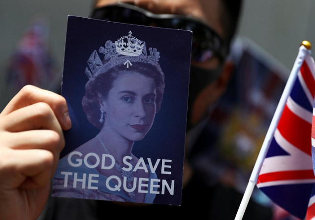 an anti government protester holds up a union jack flag and a placard with a likeness of queen elizabeth at the british consulate general in hong kong china photo reuters an anti government protester holds up a union jack flag and a placard with a likeness of queen elizabeth at the british consulate general in hong kong china photo reuters