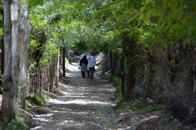 in this picture taken on may 18 2019 pakistani women walk on rural street in booni village in chitral photo afp