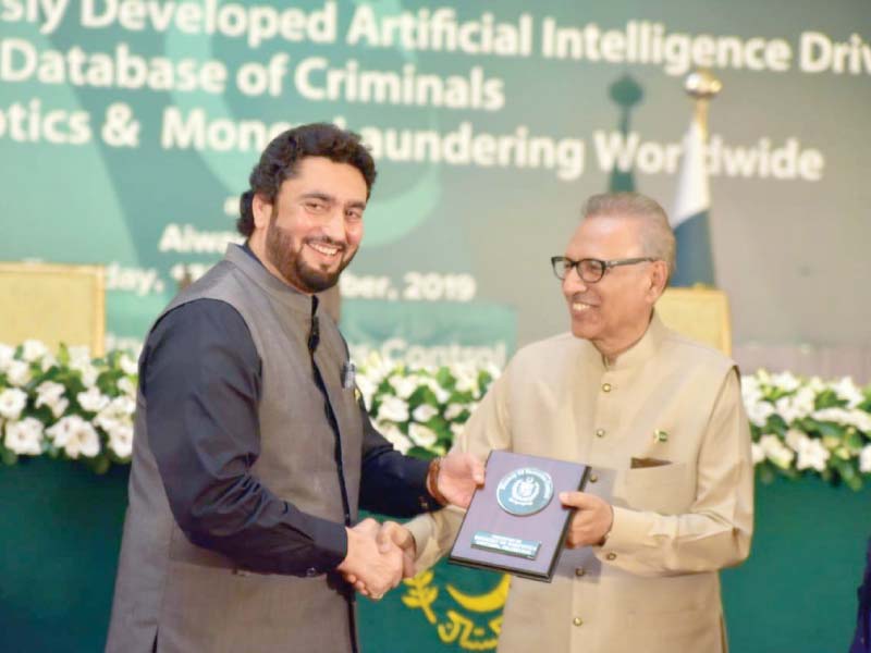 president arif alvi awarding state minister for narcotics control shehryar afridi with a shield for the initiative of establishing the databank photo express