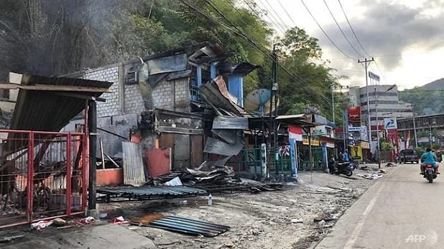 torched shops in jayapura indonesia photo afp