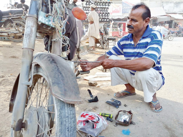 naeem is one among millions of daily wage earners who set out of their homes every morning to earn a day s living despite around three million motorcycles in karachi thousands of roadside mechanics like him have been struggling to make ends meet photo express naeem is one among millions of daily wage earners who set out of their homes every morning to earn a day s living despite around three million motorcycles in karachi thousands of roadside mechanics like him have been struggling to make ends meet photo express