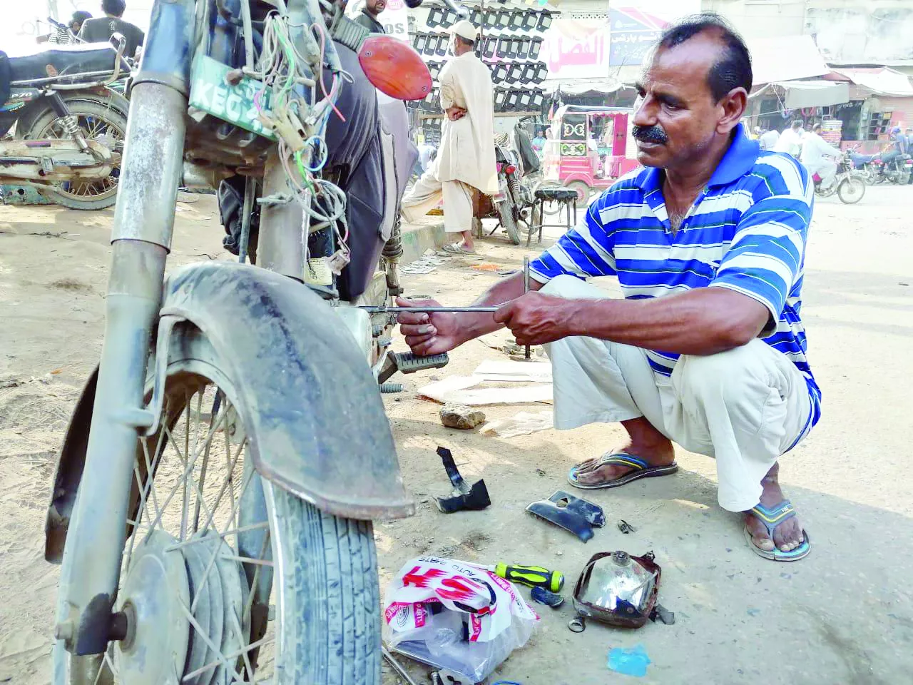 naeem is one among millions of daily wage earners who set out of their homes every morning to earn a day s living despite around three million motorcycles in karachi thousands of roadside mechanics like him have been struggling to make ends meet photo express naeem is one among millions of daily wage earners who set out of their homes every morning to earn a day s living despite around three million motorcycles in karachi thousands of roadside mechanics like him have been struggling to make ends meet photo express